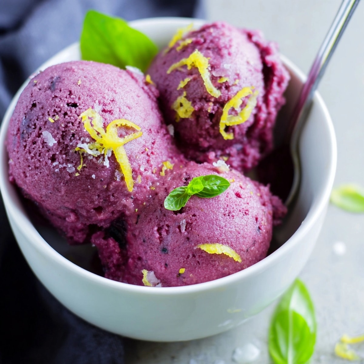 Scoops of vibrant Blueberry & Basil Lemonade Sorbet, a refreshing swirl of summer flavors.