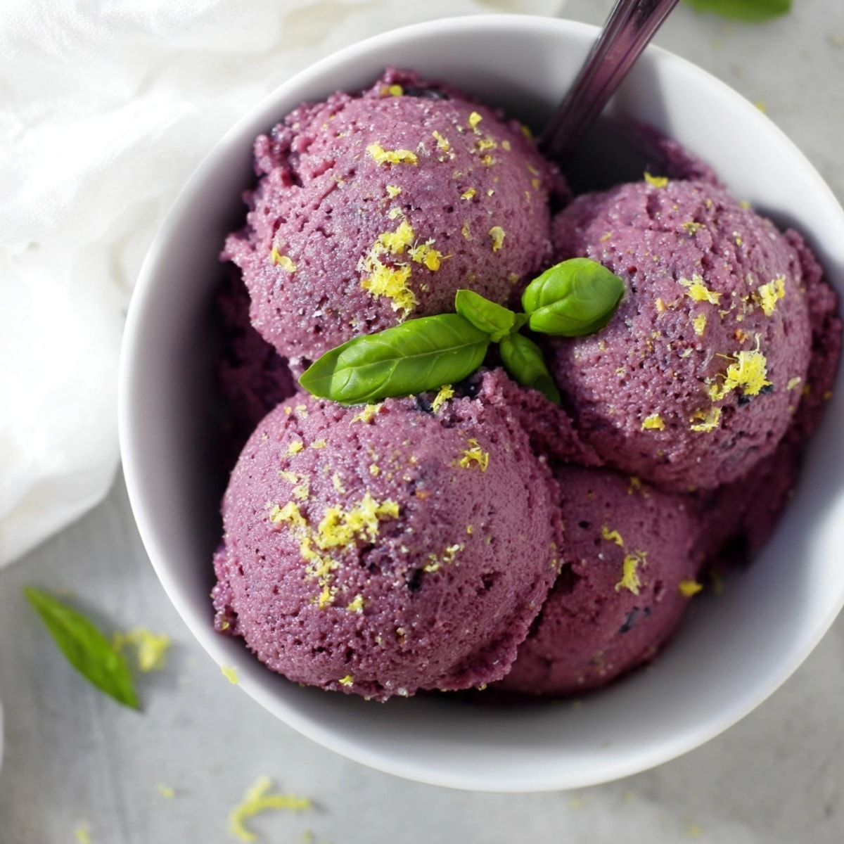 Homemade Blueberry &amp; Basil Lemonade Sorbet: see the icy texture and sugared basil garnish.