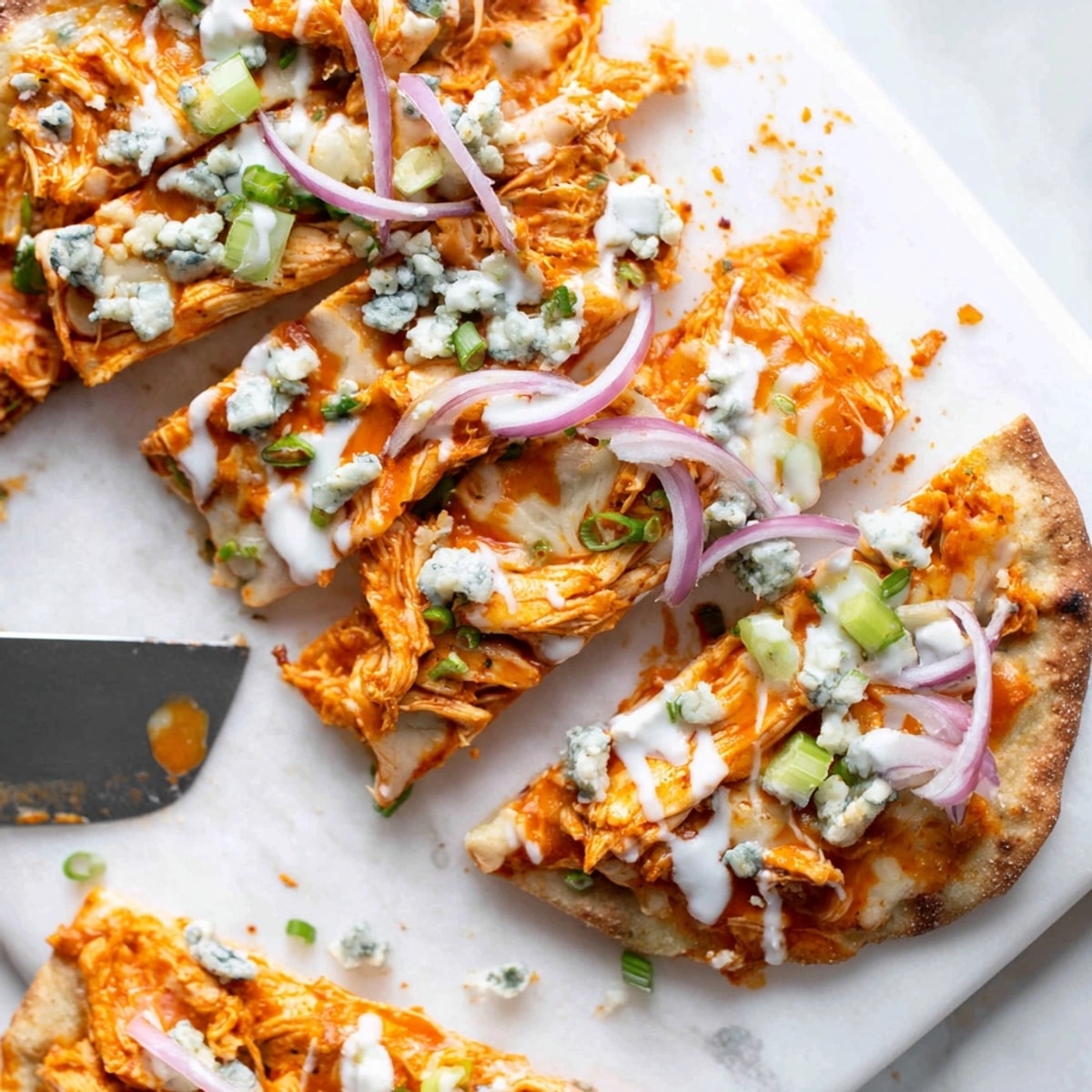 Homemade Buffalo Chicken and Blue Cheese Flatbread on a wooden board, garnished vibrantly.