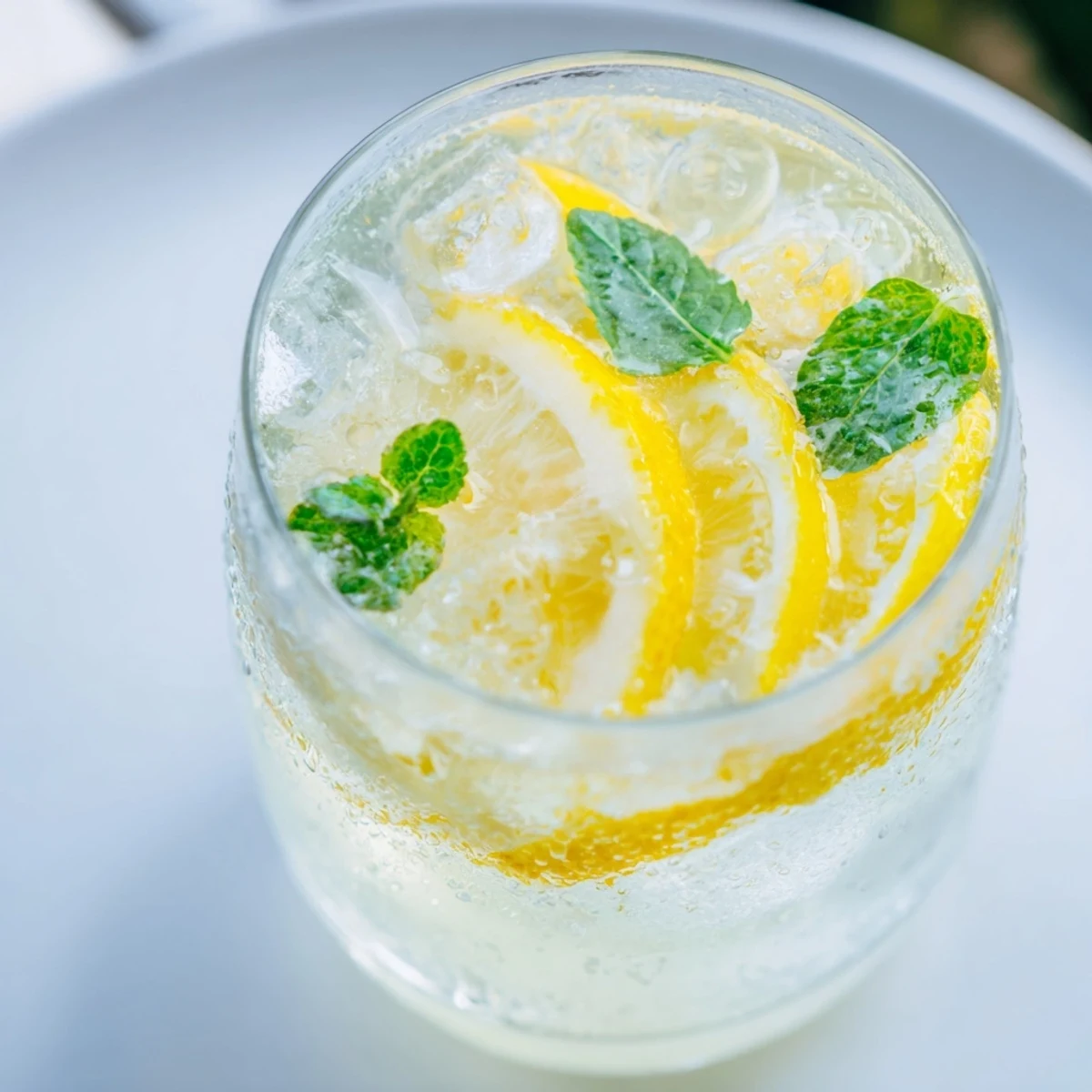 Bright yellow lemonade in a pitcher, perfect to quench your thirst on a hot summer afternoon.
