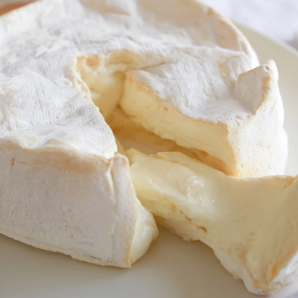 Soft, melty interior of delicious Brie cheese pairs well with fresh fruit and crackers.