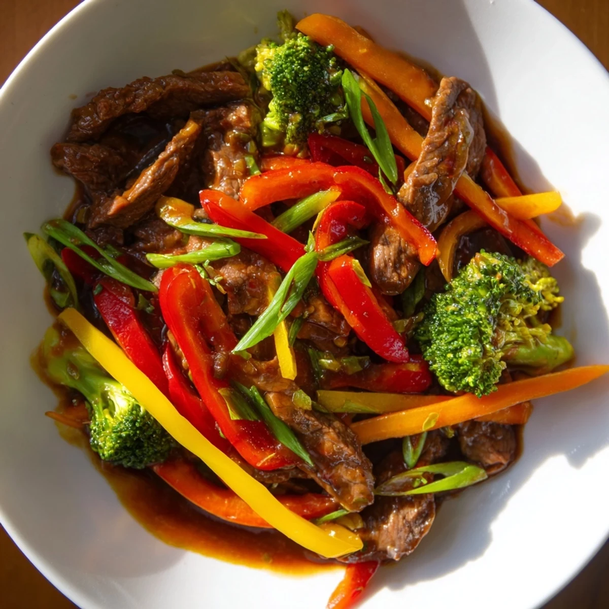 Tender beef stir fry with colorful vegetables glistening in a rich, savory sauce.
