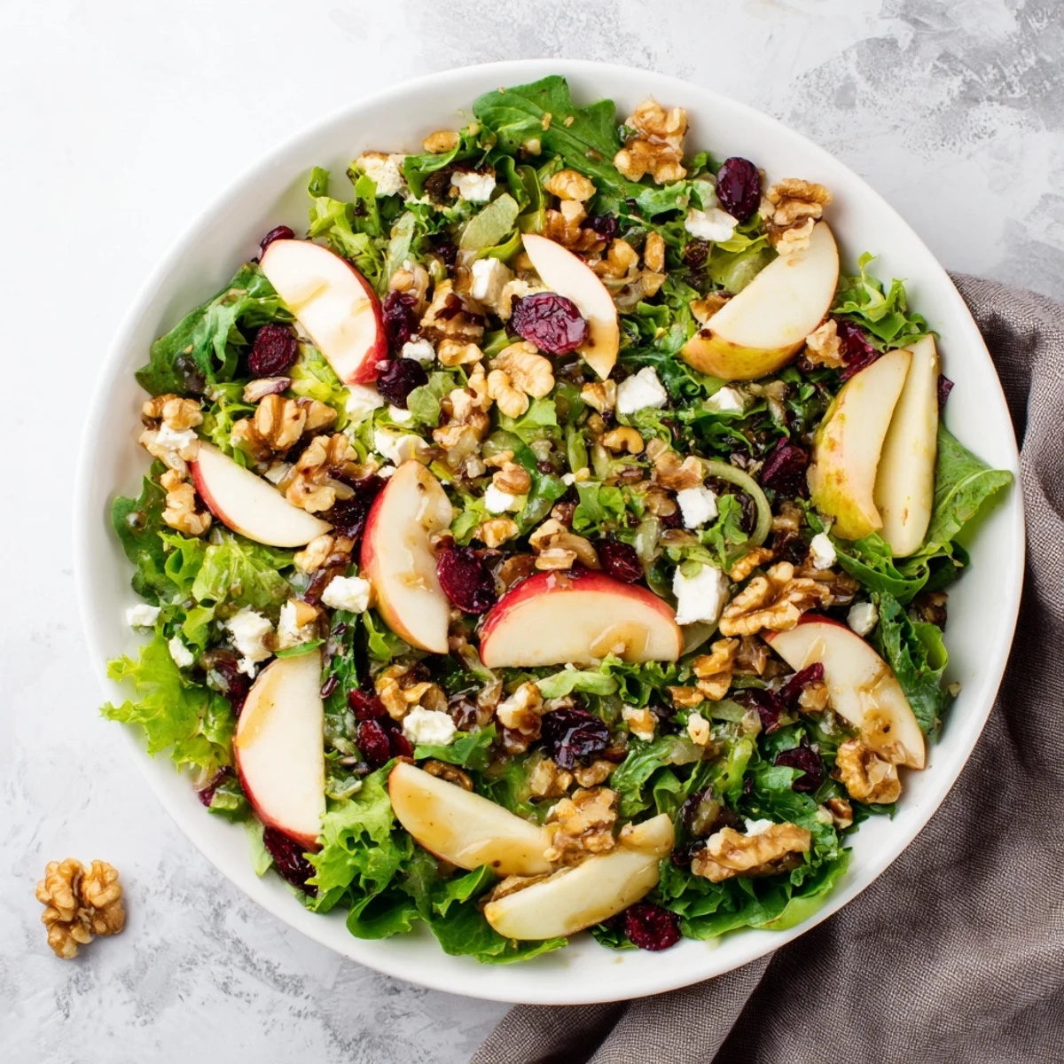 Vibrant image of a finished walnut salad: a healthy mix of textures and bright colors.