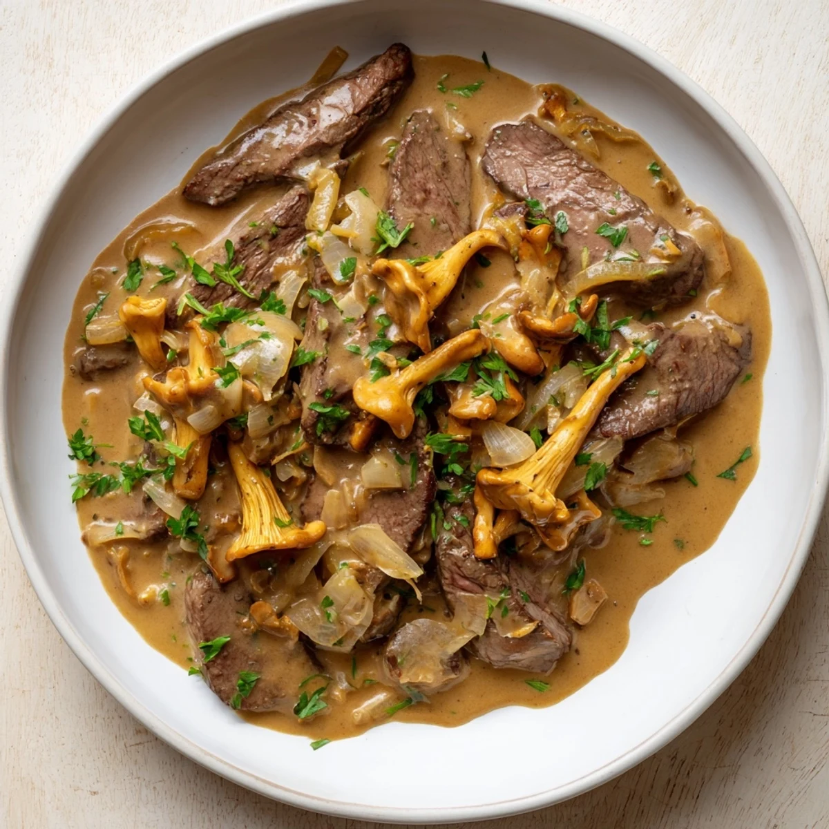 Tender beef stroganoff with wild mushrooms, a creamy, savory delight served over egg noodles.