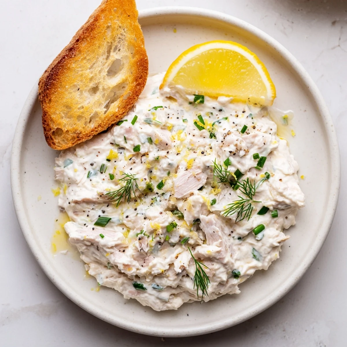 Close-up of Smoked Mackerel Pate: a beautifully textured, savory dip with fresh herbs and toast.