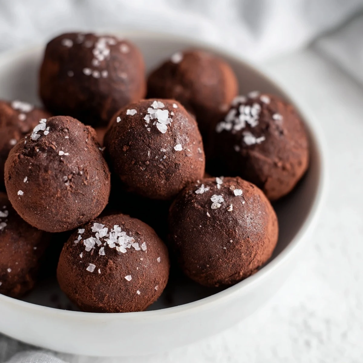 Silky, homemade dark chocolate truffles with sea salt, perfect for a special occasion dessert.