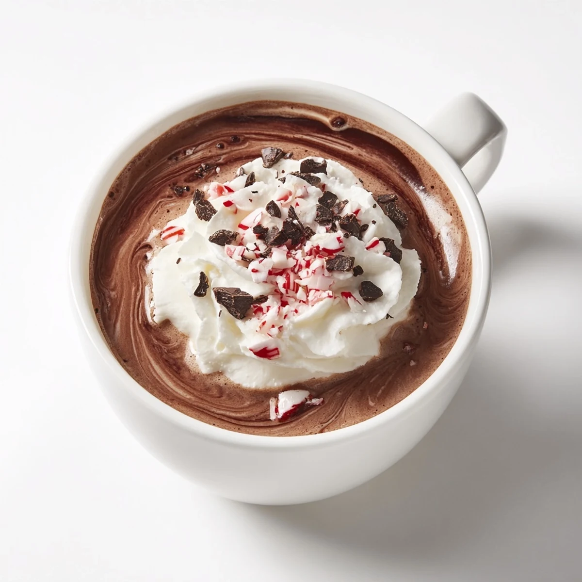 Rich dark swirled Cocoa Peppermint, topped with chocolate shavings, offering a delightful winter beverage.