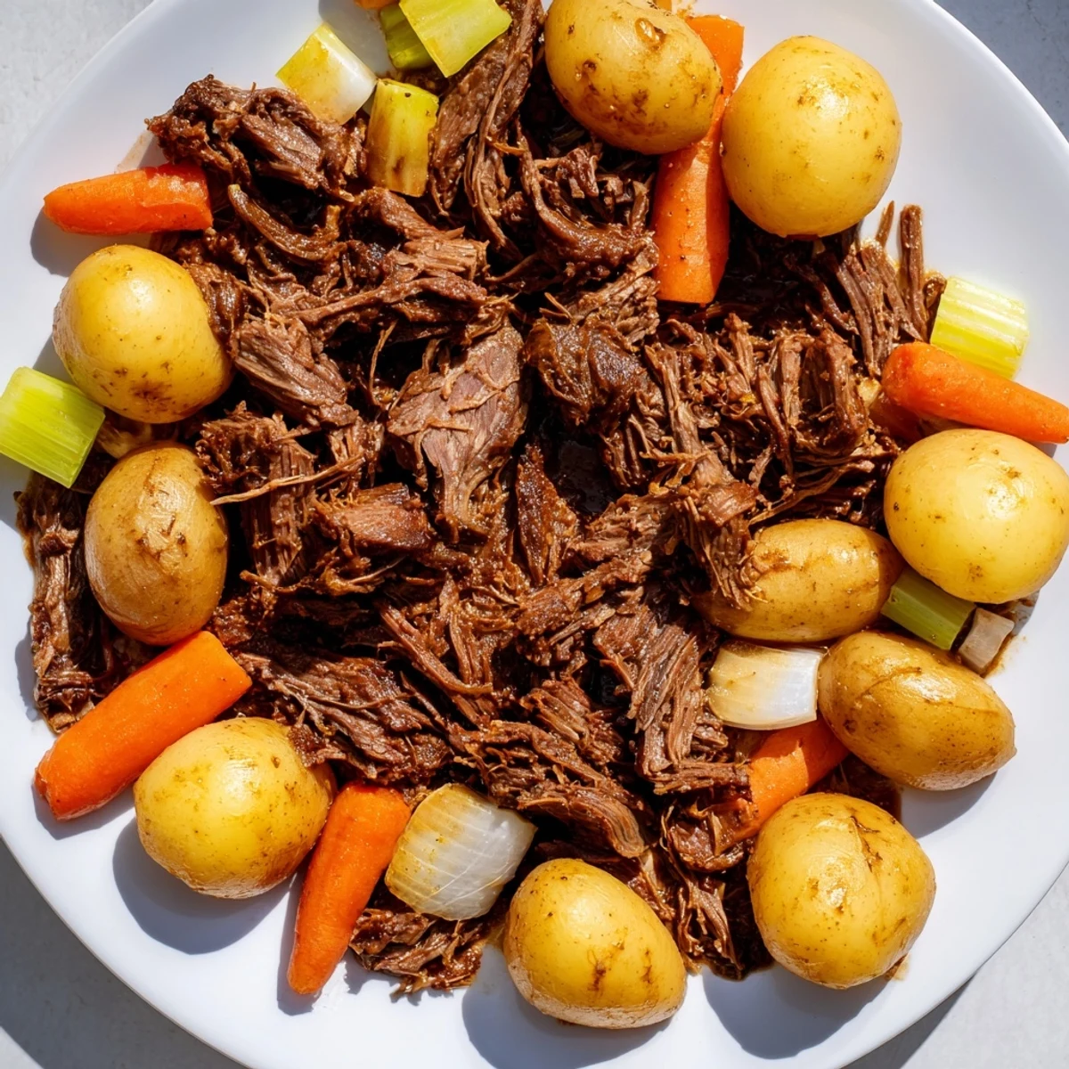 Golden-brown beef chuck, surrounded by tender veggies in hearty slow cooked pot roast.