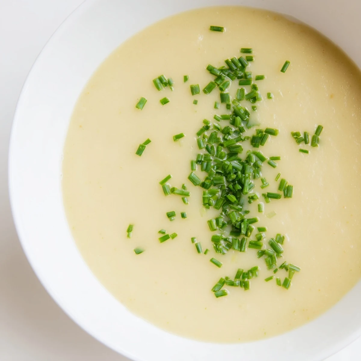 Creamy potato leek soup, a smooth, velvety French soup garnished with fresh, snipped chives.