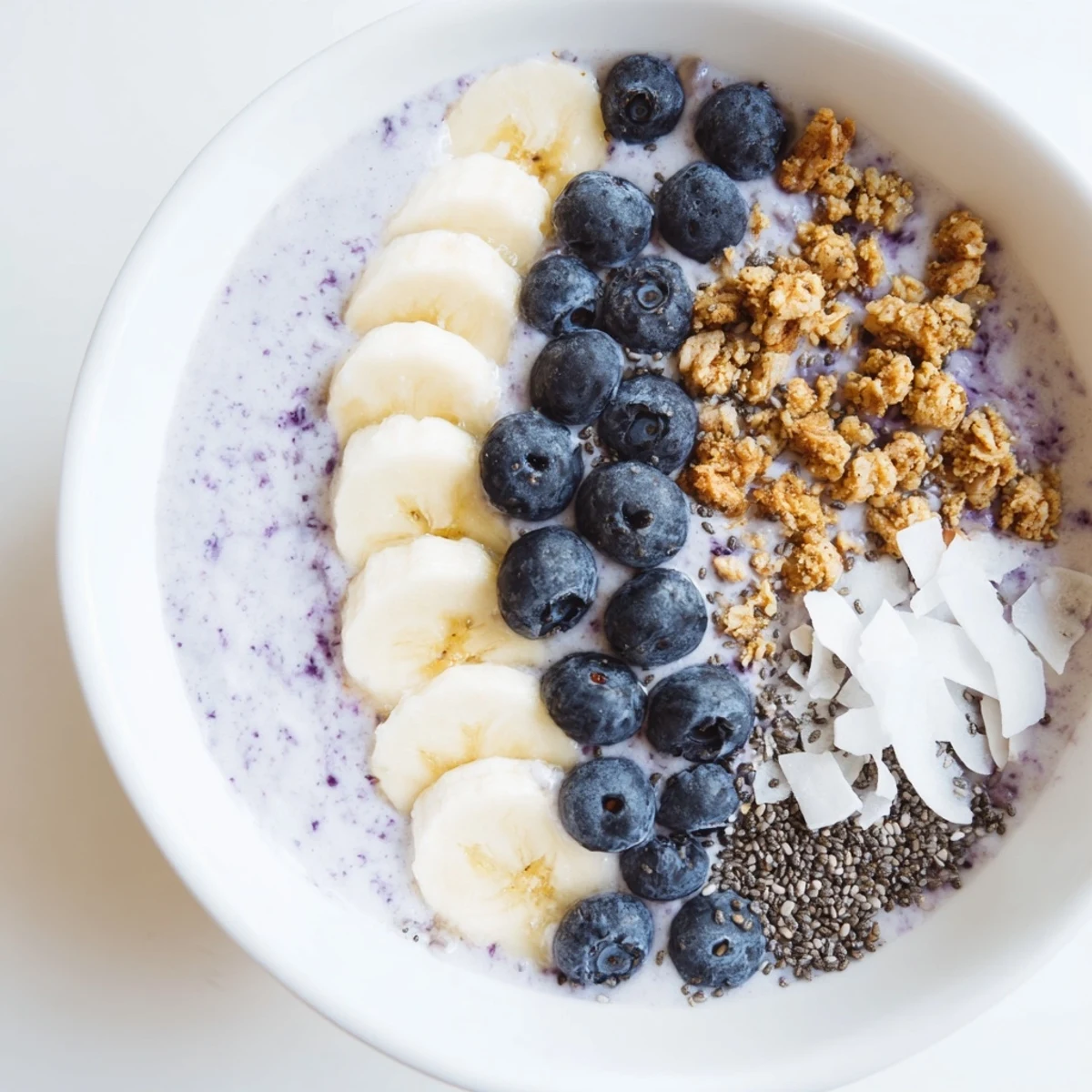 Bright, colorful close-up of a lemon blueberry smoothie bowl, showcasing fresh blueberry toppings.