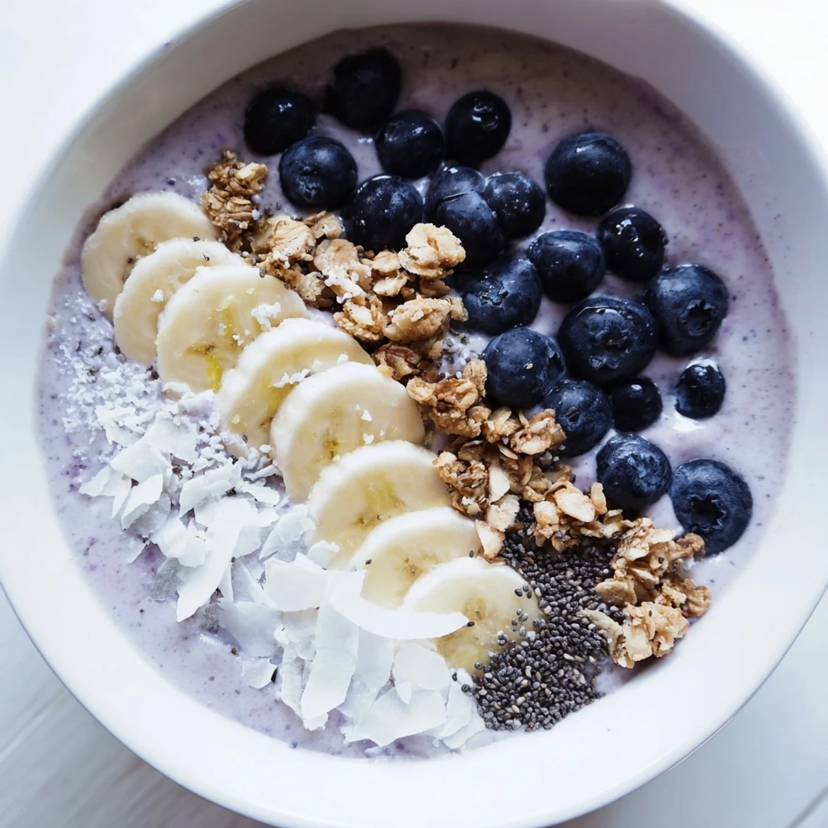 A delightful view of a thick lemon blueberry smoothie bowl, ready to enjoy as a light, tasty meal.