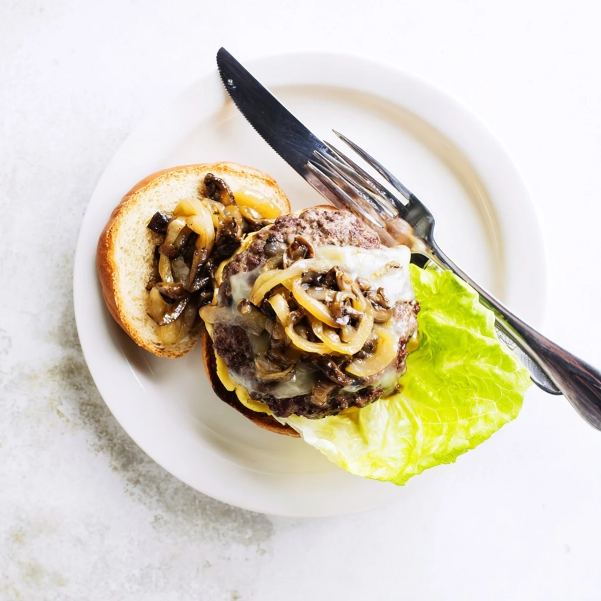 A juicy Mushroom and Swiss Burger with caramelized onions on a toasted bun, ready to serve.