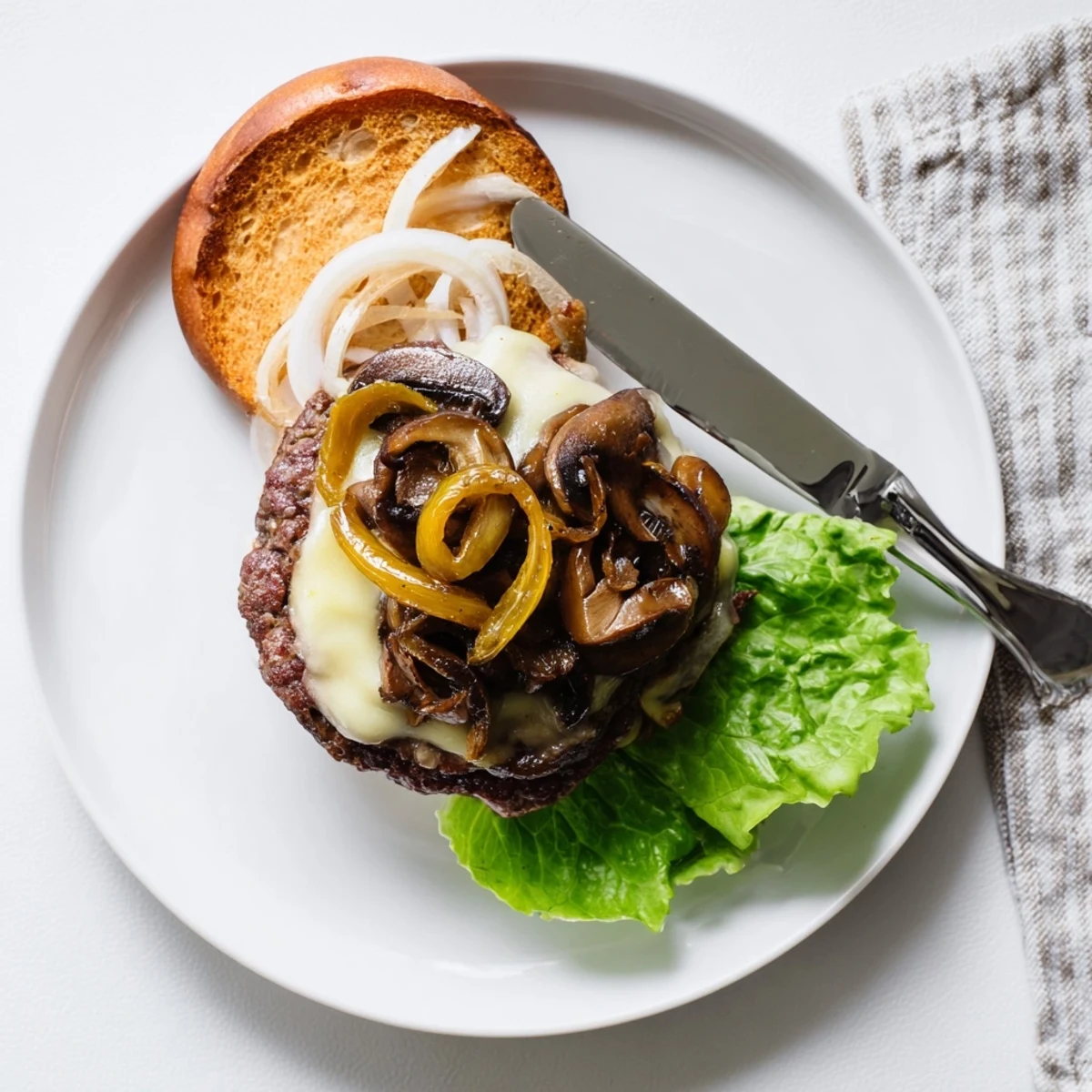 Freshly prepared Mushroom and Swiss Burger, topped with sweet caramelized onions and served with golden fries.