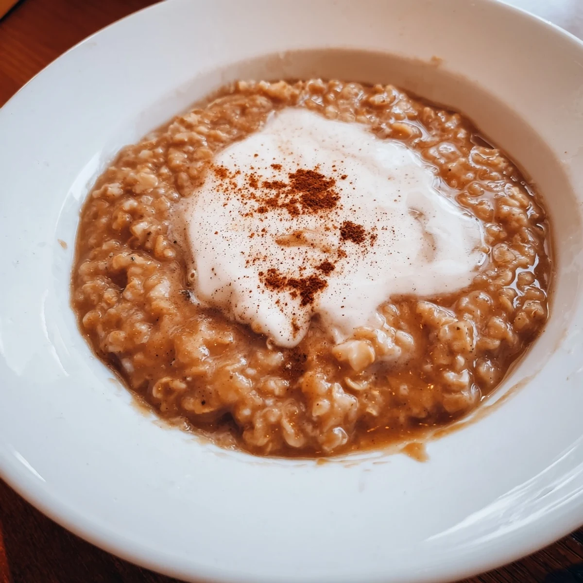 A comforting bowl of Irish Oatmeal with Brown Sugar and Cream, perfect for a cozy breakfast or brunch.