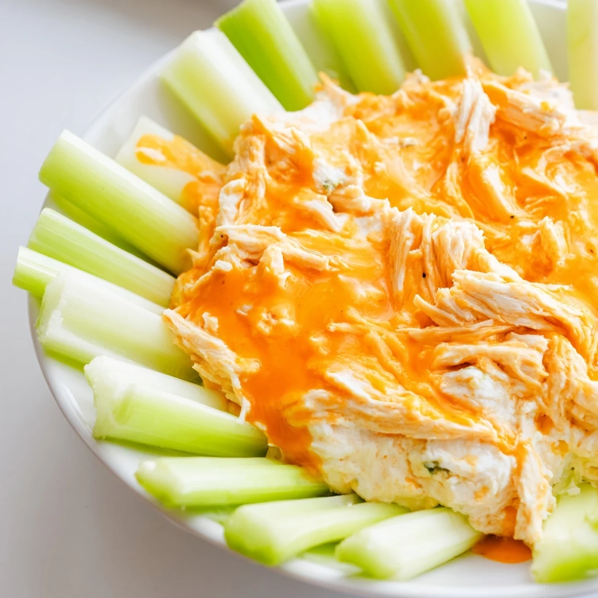 Warm and creamy Spicy Buffalo Chicken Dip in a baking dish, perfect for game day appetizers.