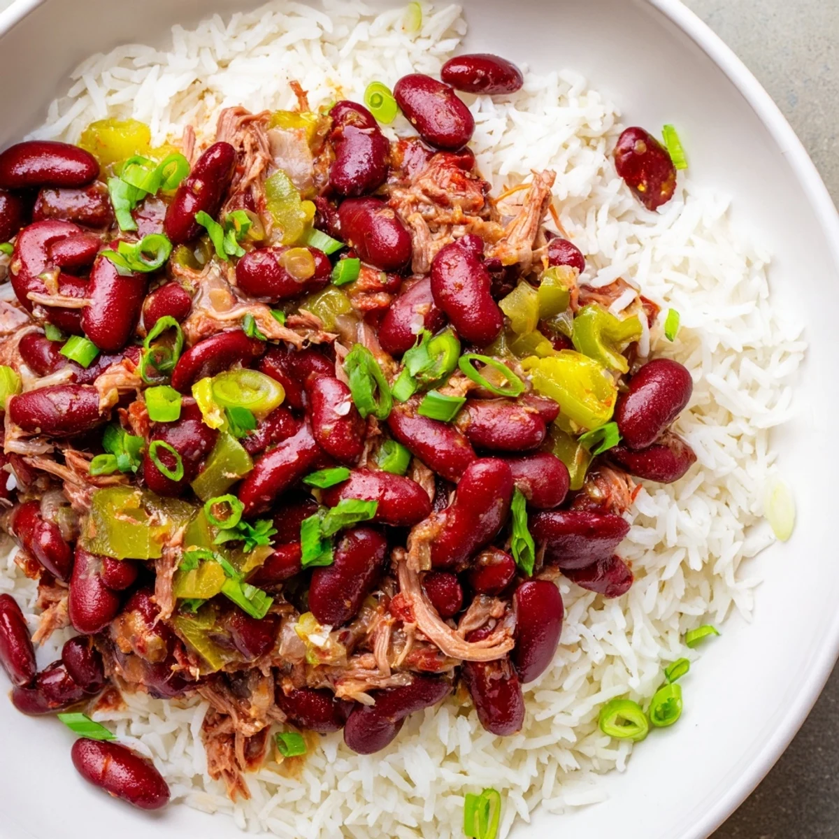 Savory Creole Red Beans and Rice with Smoked Turkey simmered in spices, served steaming in a rustic bowl with fluffy rice.  