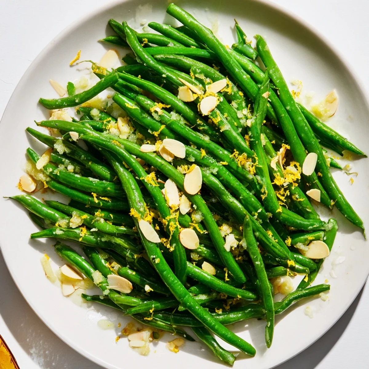Vibrant crisp-tender Green Beans with Toasted Almonds and Lemon tossed in garlic butter, finished with bright zest.