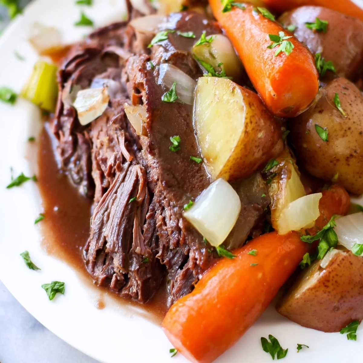 Fork-tender shredded beef and glazed root vegetables served in a cozy bowl with rich gravy.