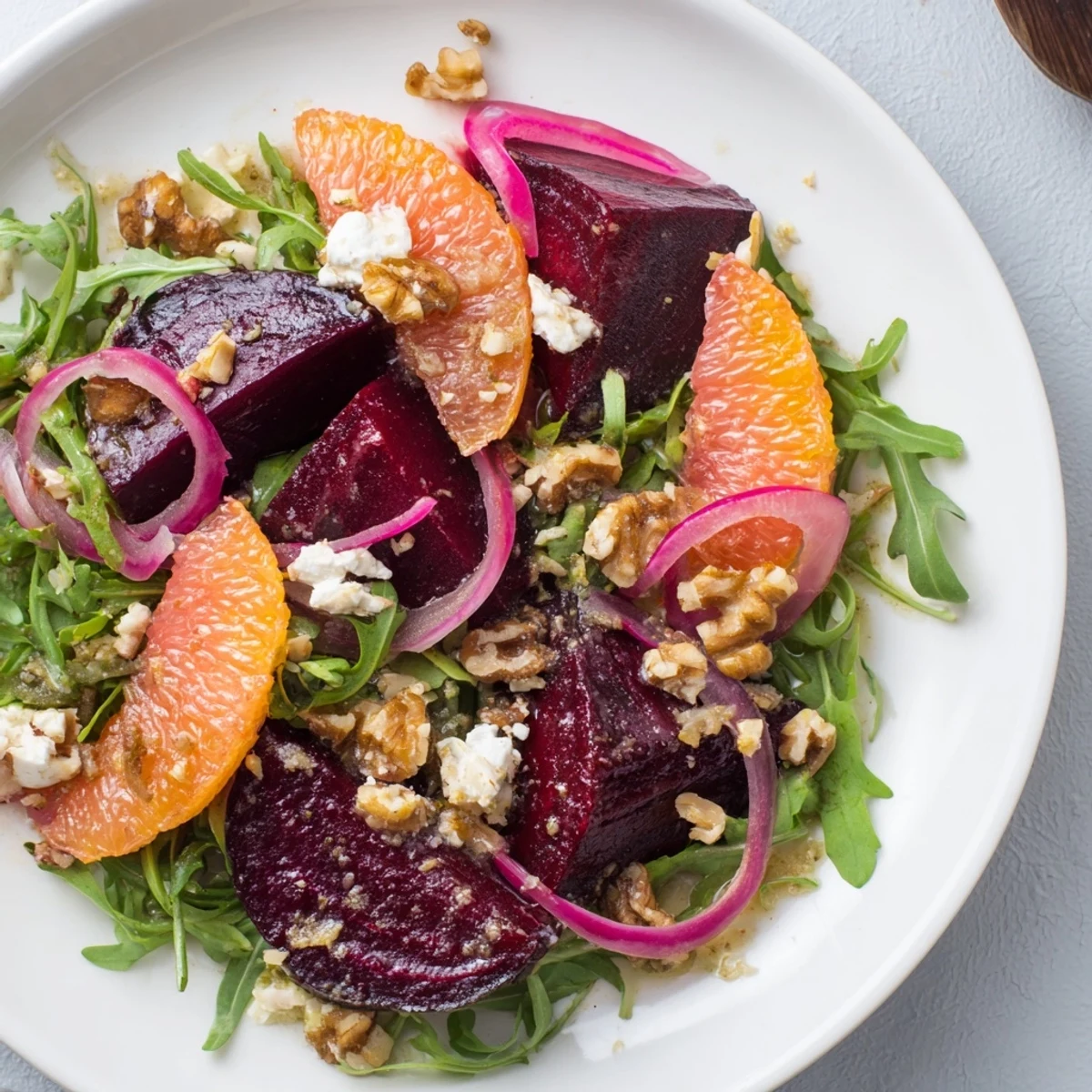Served Roasted Beet and Citrus Salad in a rustic wooden bowl, paired with a glass of crisp white wine for a light lunch.