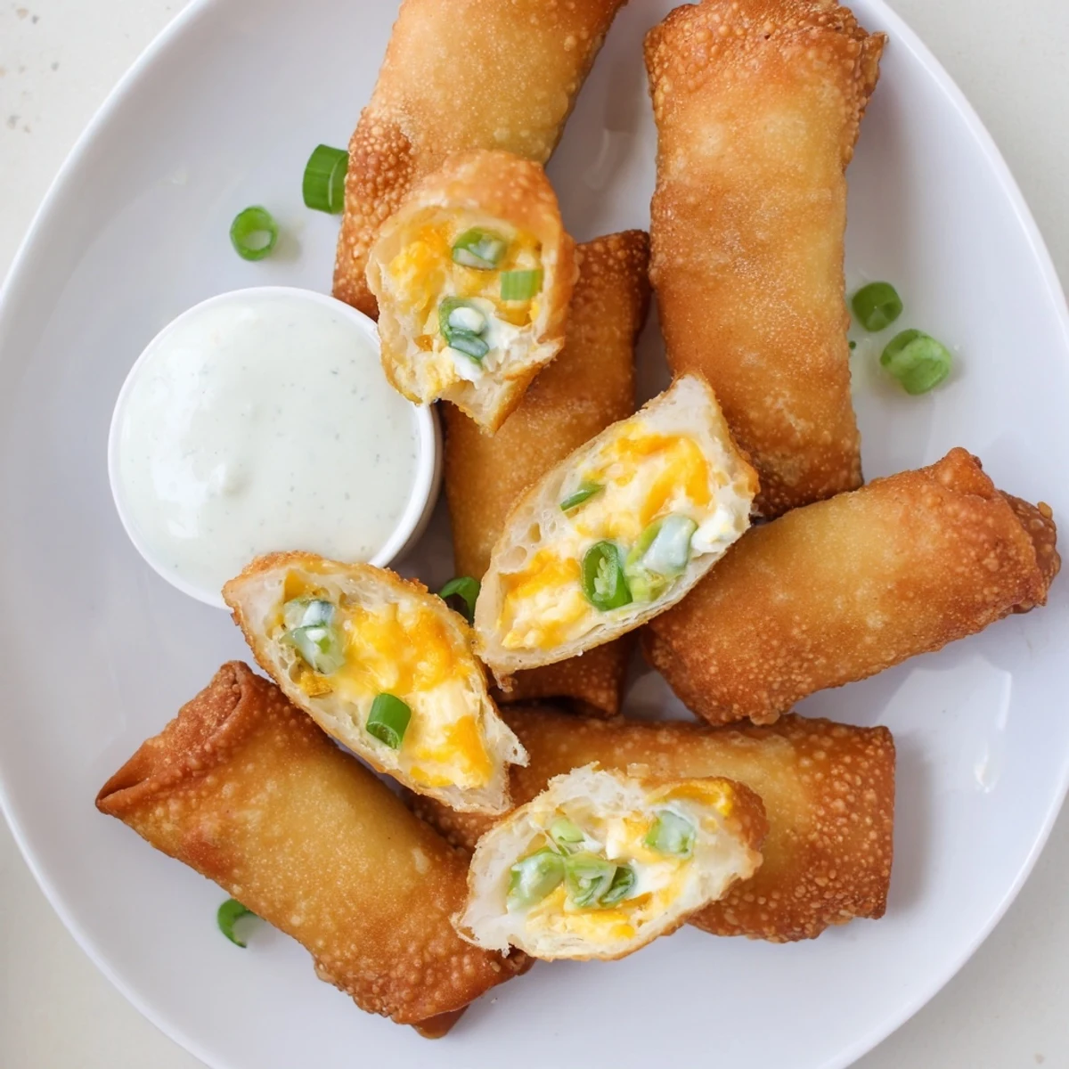 Crispy Mini Jalapeño Popper Egg Rolls served warm with creamy ranch for a game day snack.