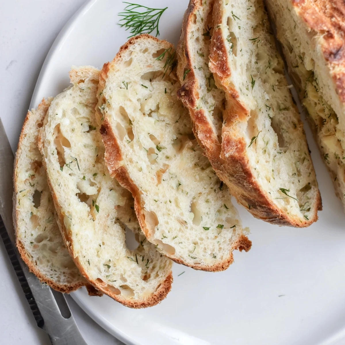 Freshly baked No Knead Dill Gouda Artisan Bread with golden crust and melty cheese.