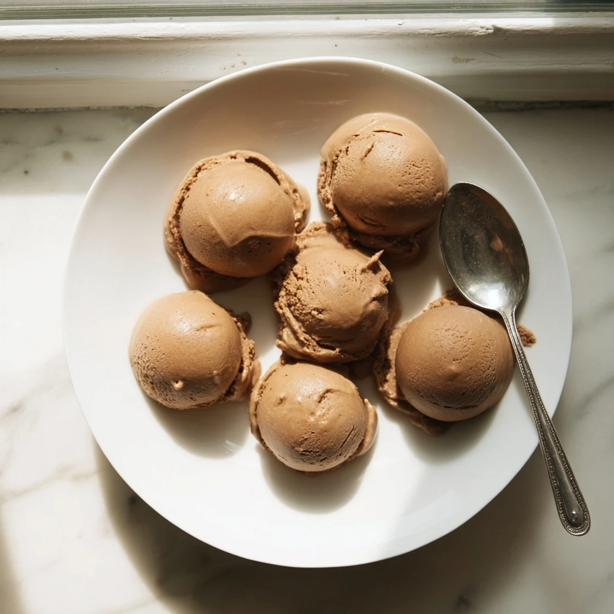 Serve this indulgent Vietnamese Coffee Ice Cream in a tall glass, layered with crushed ice and a shot of hot espresso.