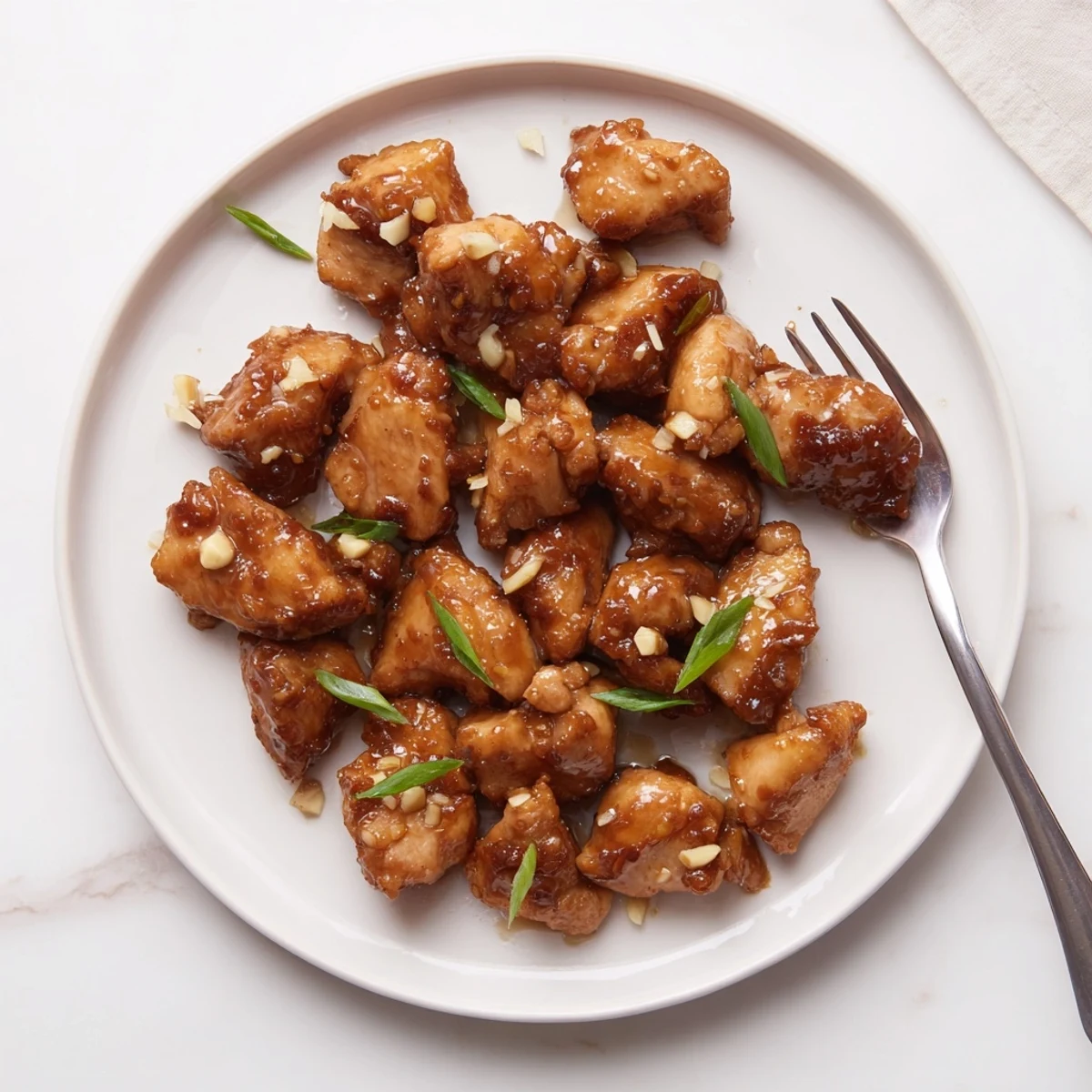 Close up of juicy Mongolian chicken stir-fried with aromatic garlic and ginger in a rich brown glaze