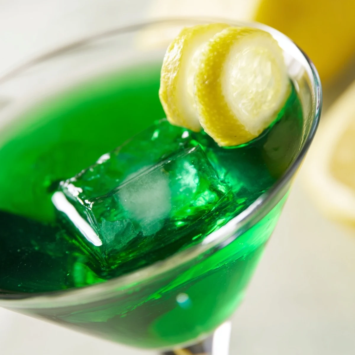 Luck of the Irish cocktail featuring emerald Irish whiskey blend with citrus and lemon twist
