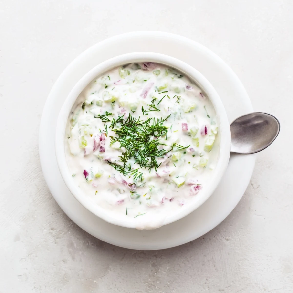 Thick spicy dill pickle burger sauce layered on a toasted brioche bun with melted cheddar cheese