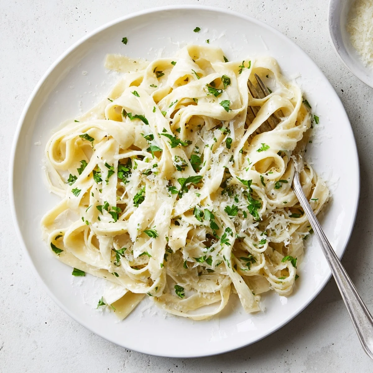 Creamy fettuccine Alfredo pasta tossed in rich white sauce sprinkled with grated cheese