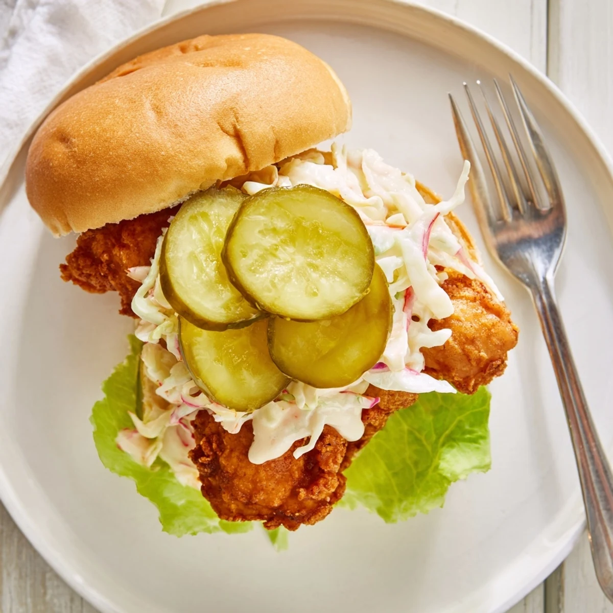 Homemade Southern fried chicken burgers featuring juicy spiced chicken fillets with creamy coleslaw and dill pickles