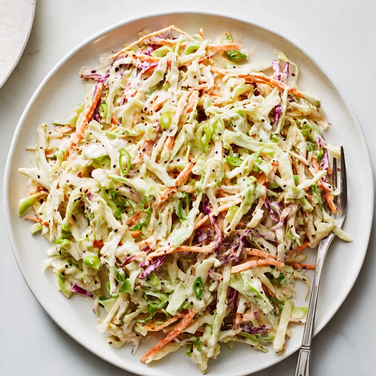 Crisp shredded green and red cabbage tossed in creamy white dressing for this easy creamy coleslaw