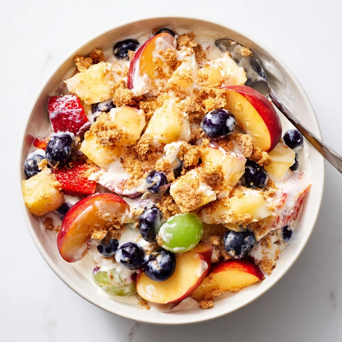Summer peach cobbler cheesecake fruit salad swirl with fresh mixed fruit and crispy buttery vanilla wafer topping