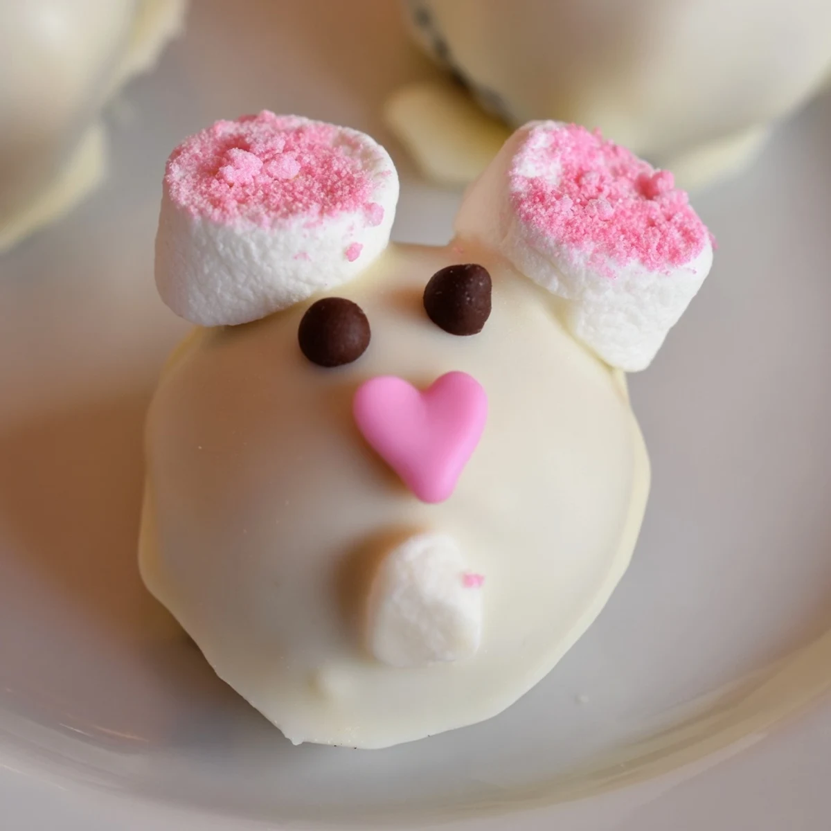 Closeup of adorable Easter Bunny Oreo Balls featuring cream cheese Oreo truffles decorated as cute spring bunnies