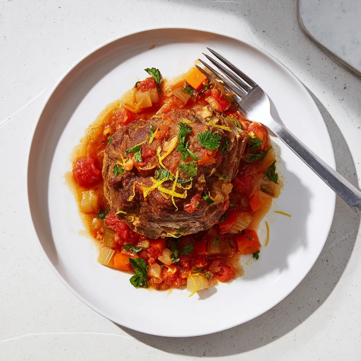 Ina Garten style Osso Buco with fork tender veal shanks nestled in aromatic vegetable and tomato broth