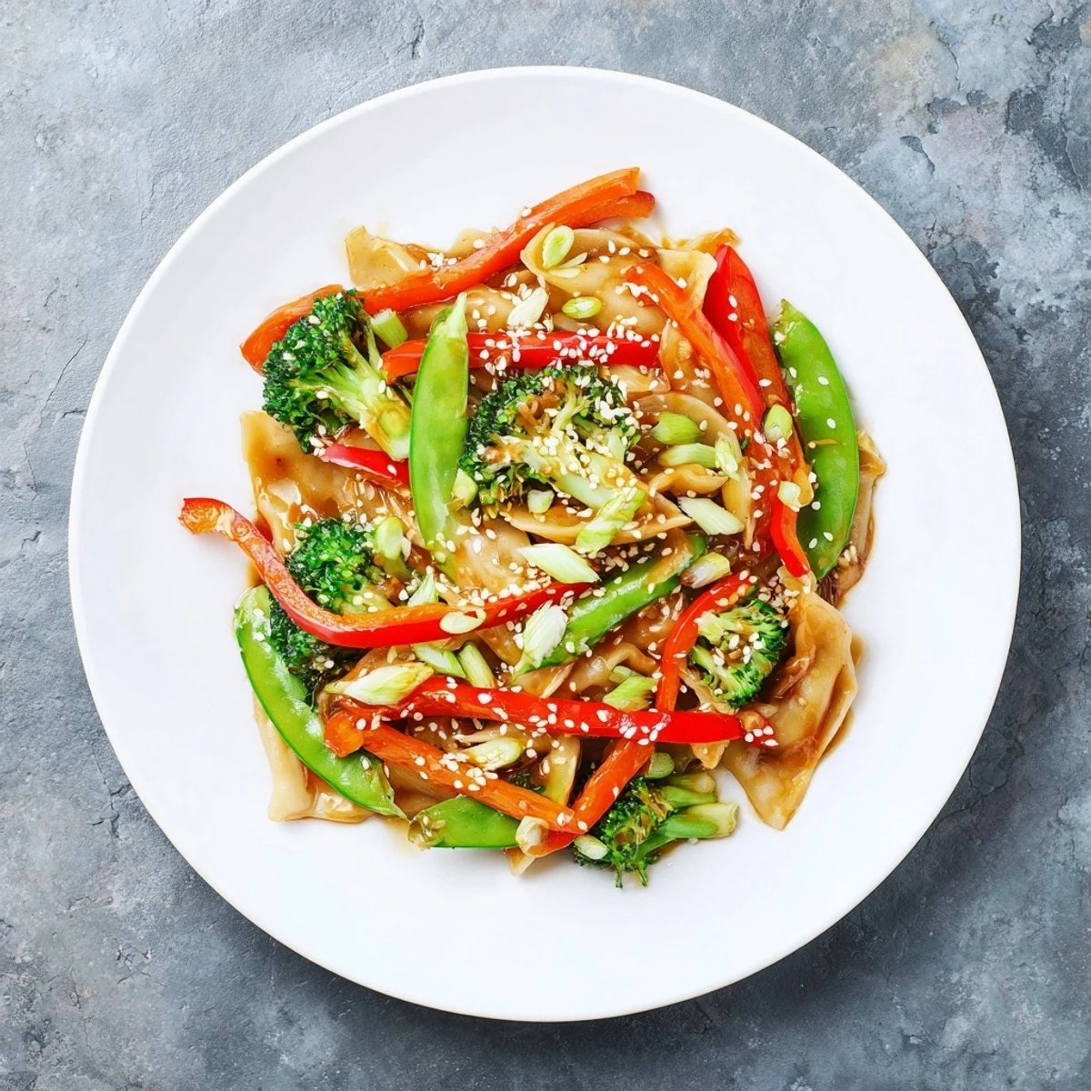 Vibrant Asian-inspired dumpling vegetable stir fry glistening with thick aromatic garlic glaze