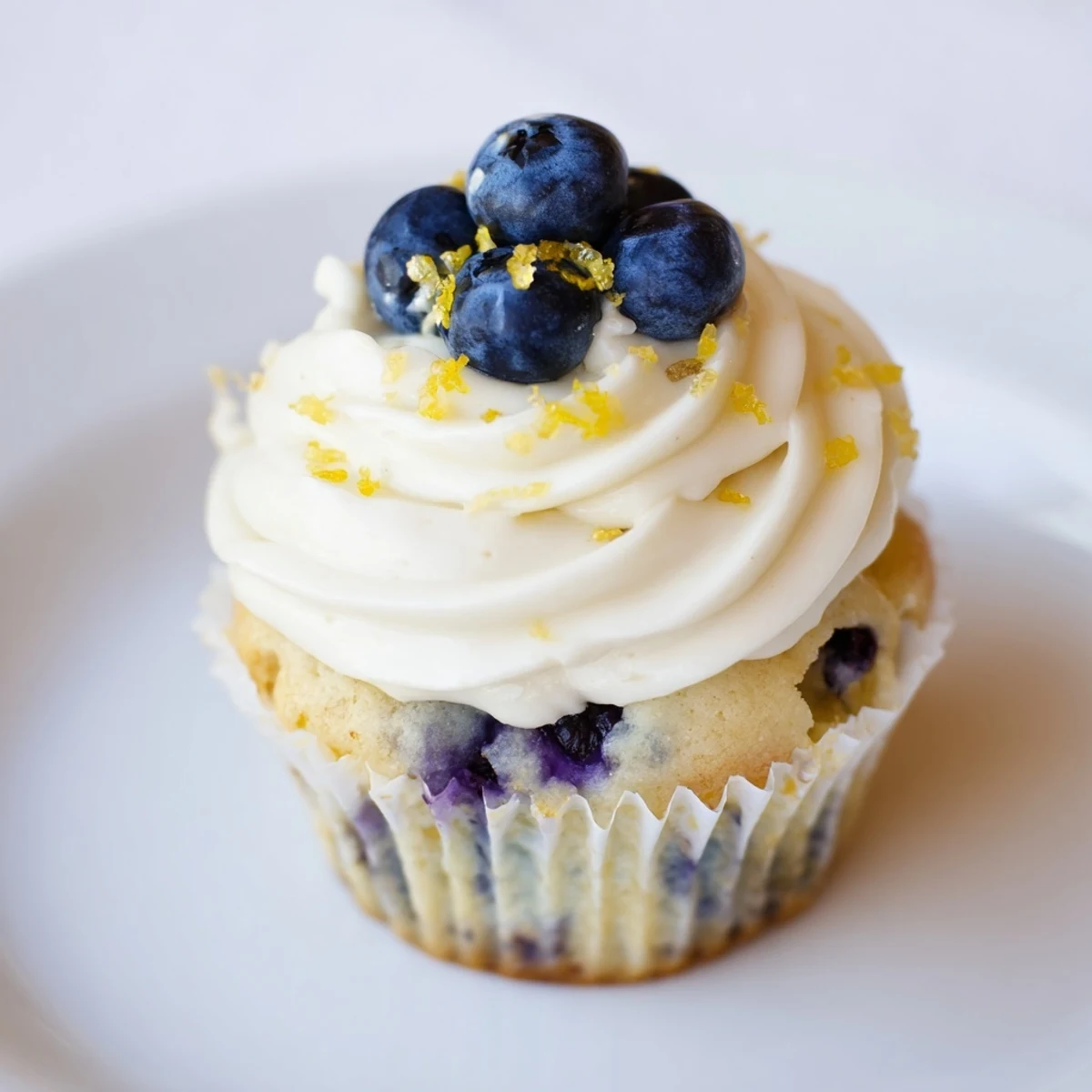 Baked lemon blueberry cupcakes bursting with fresh berries and finished with zesty lemon cream cheese frosting