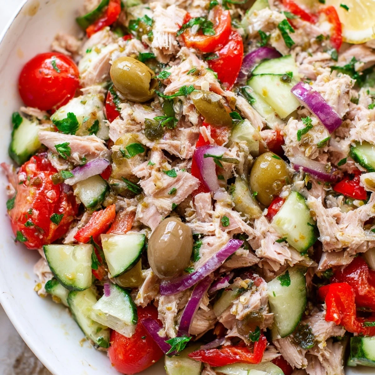 Vibrant Mediterranean tuna salad served in a bowl with fresh parsley and olives