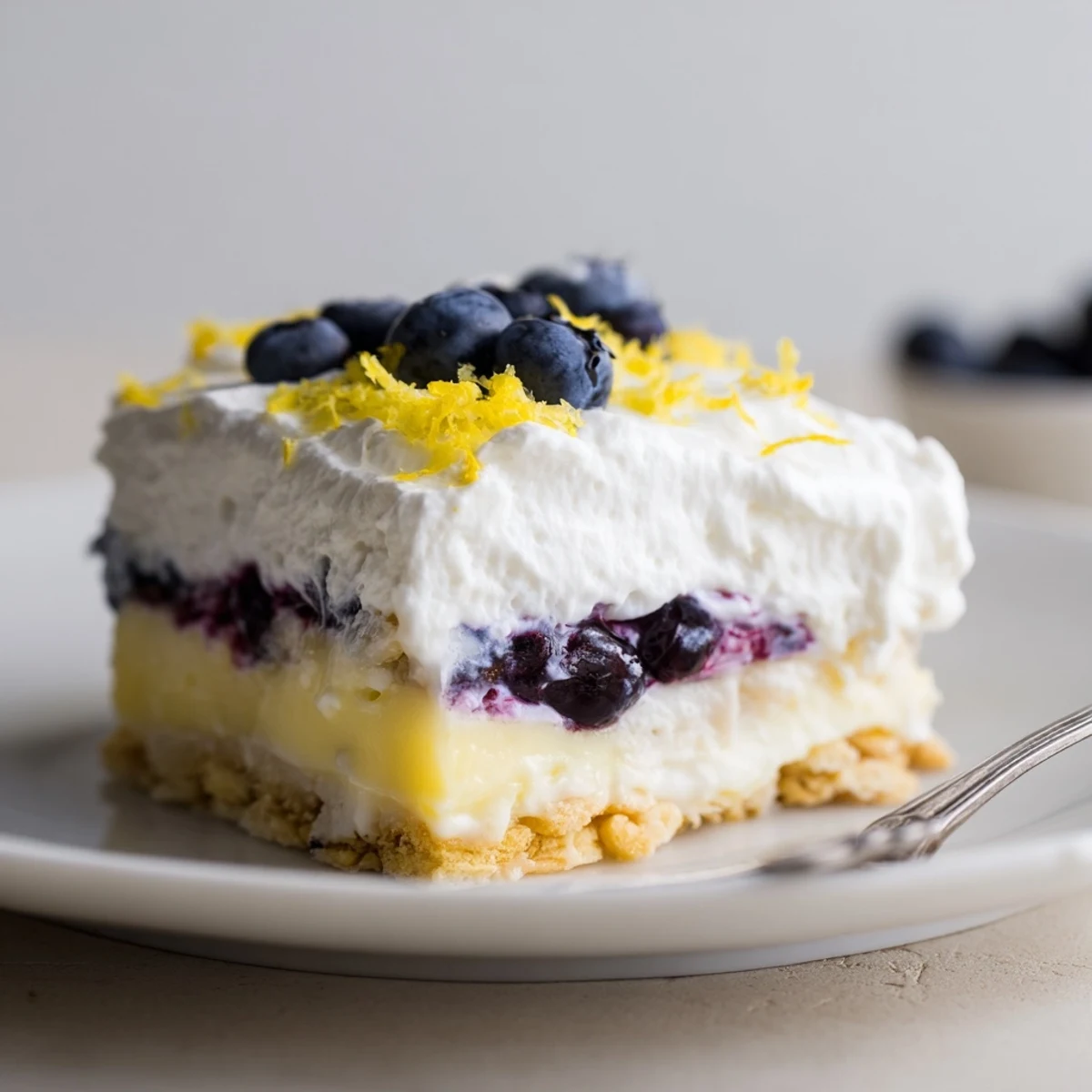 Lemon Blueberry Lasagna Recipe layered in dish, zesty cream and juicy blueberries