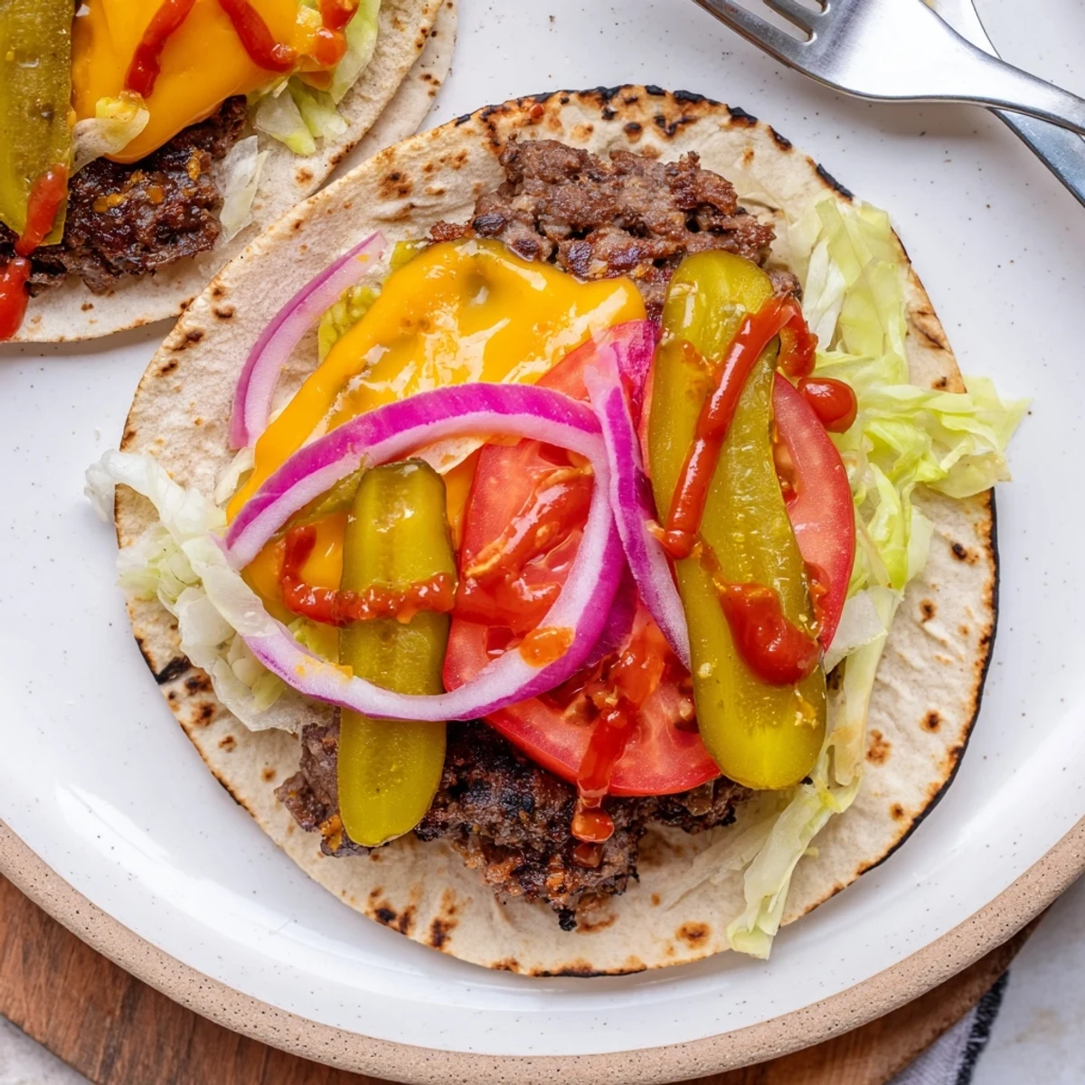 Smash Burger Tacos recipe sizzling on a griddle, edges caramelized