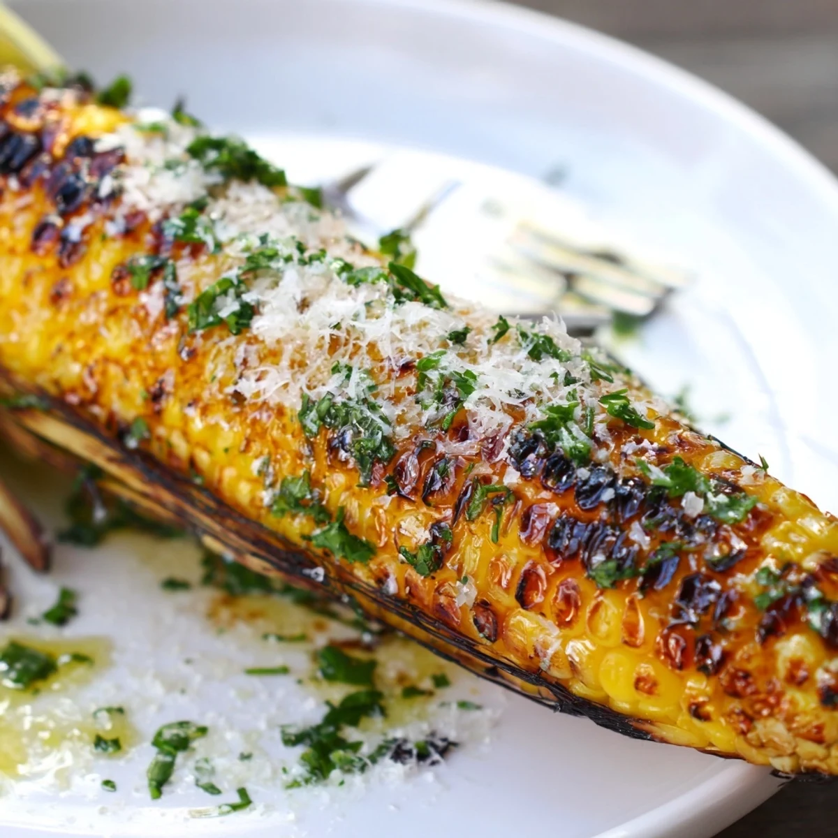 Butter-brushed Garlic Parmesan Corn On The Cob with charred kernels and garlicky aroma