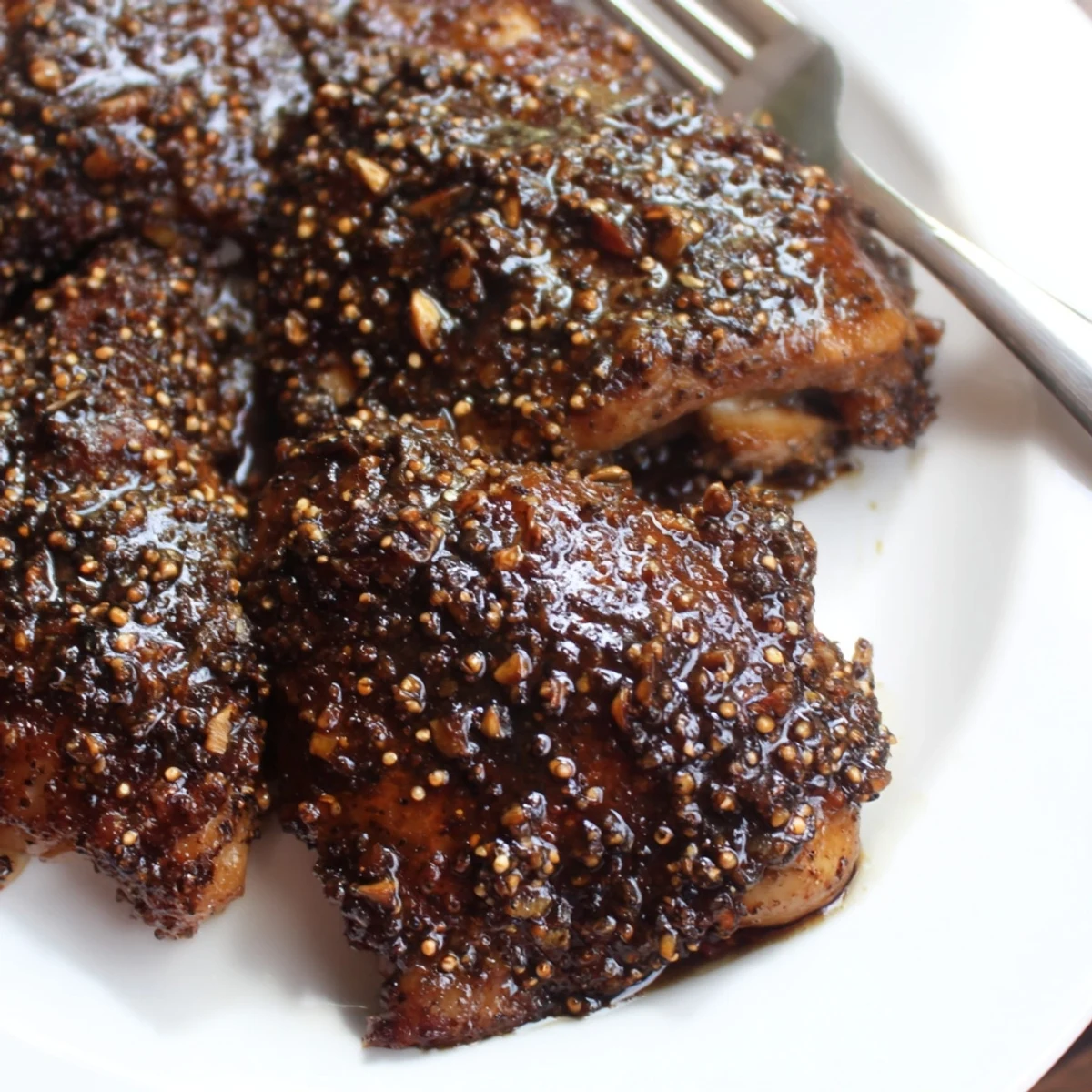 Golden pan-seared garlic black pepper chicken garnished with fresh green onions and sesame seeds