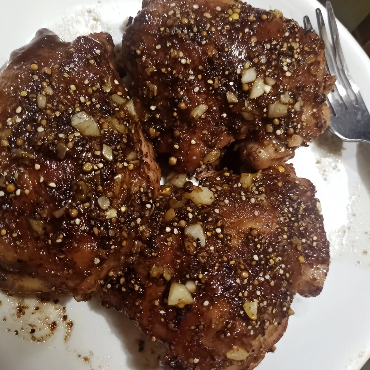 Savory garlic black pepper chicken plated with steamed vegetables and aromatic marinade glaze