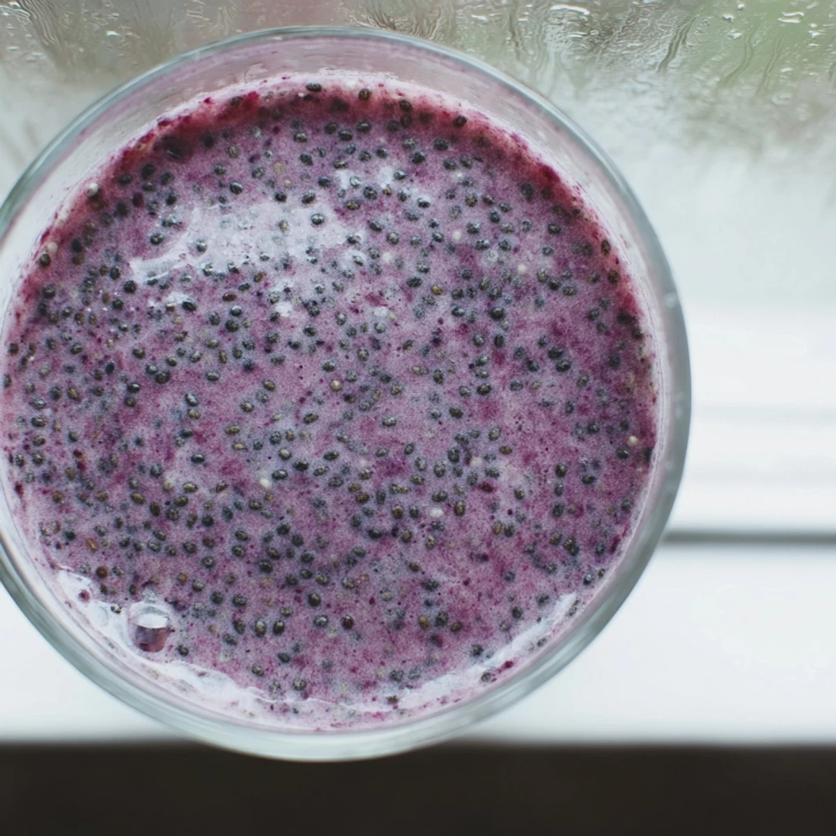 Vibrant chia seed smoothie with mixed berry swirl and garnish of whole chia seeds
