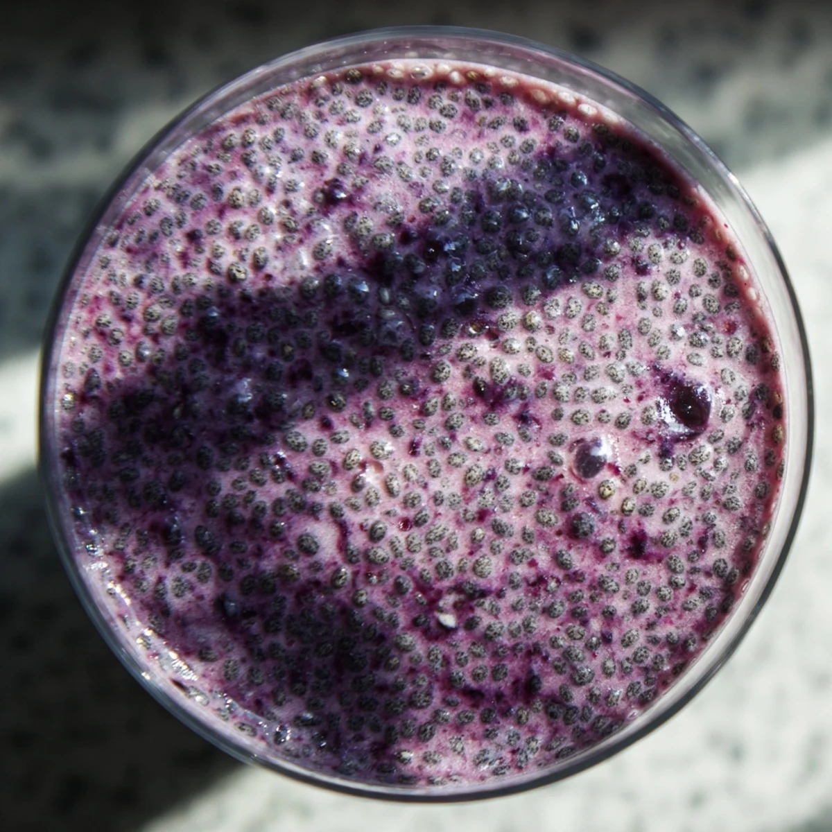 Creamy chia seed smoothie blended with frozen berries and banana in a mason jar