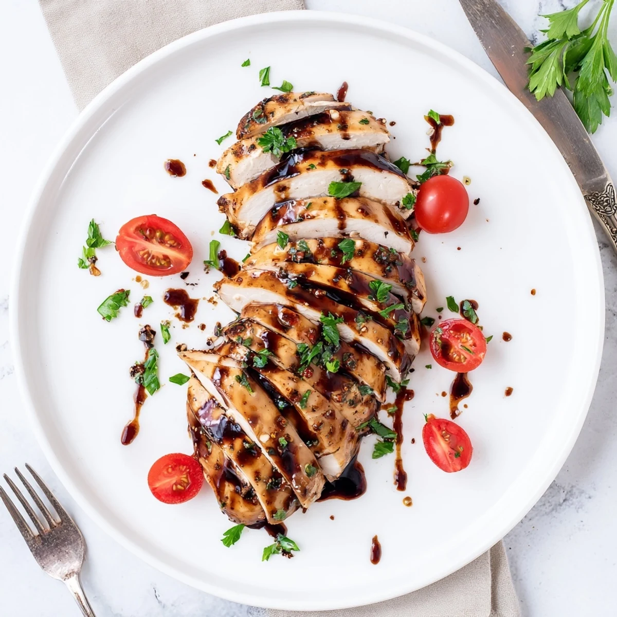 Slice-ready Balsamic Baked Chicken Breast atop roasted vegetables and cherry tomatoes