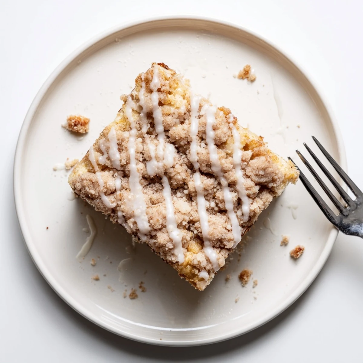 Banana Crumb Coffee Cake with golden cinnamon streusel, sliced on wooden board