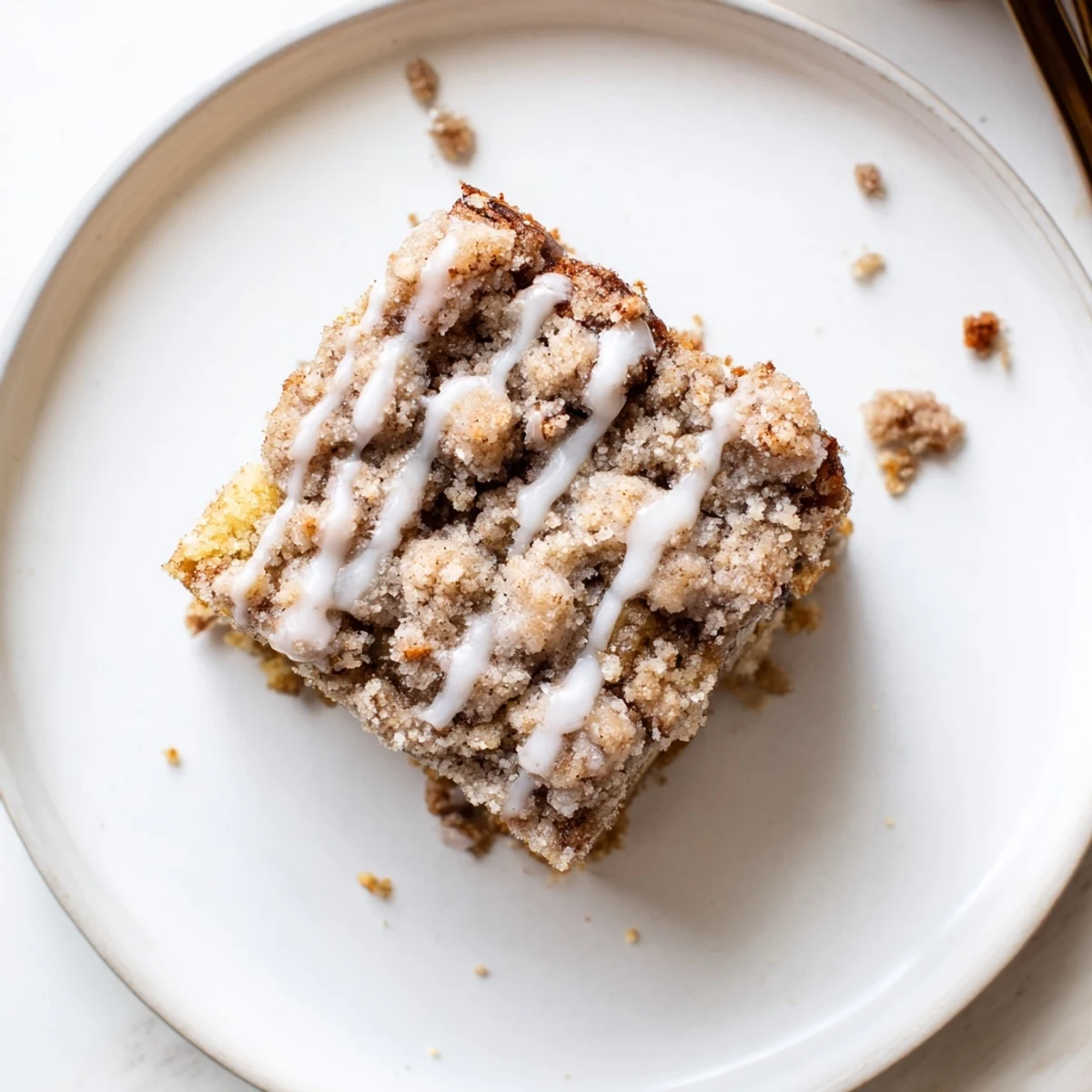 Warm Banana Crumb Coffee Cake steaming beside a mug of drip coffee