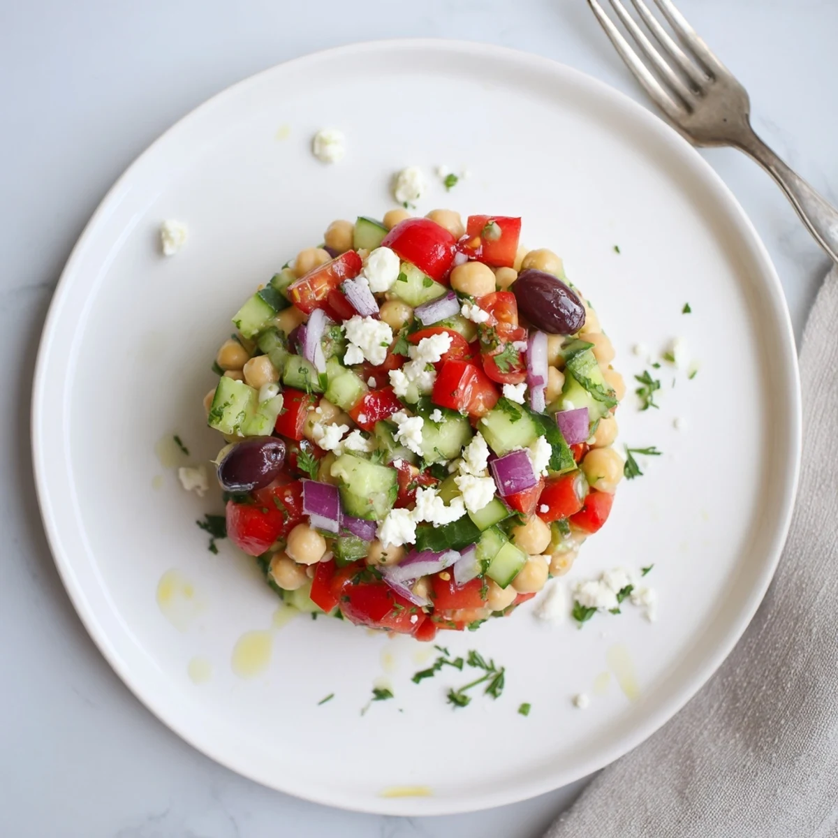 Mediterranean Chickpea Salad Recipe served chilled with briny olives and crumbled feta