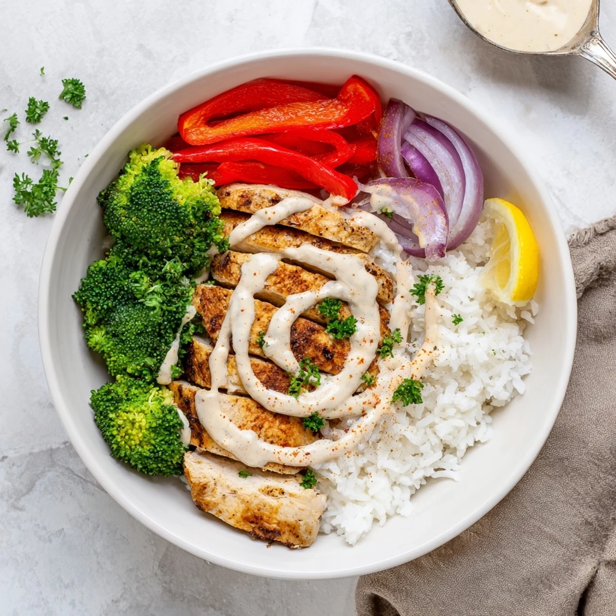 Close-up of Grilled Chicken Broccoli Bowls with Creamy Garlic Sauce, steaming and fragrant